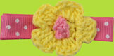 Yellow crochet flower on pink polka dot hair clip for kids